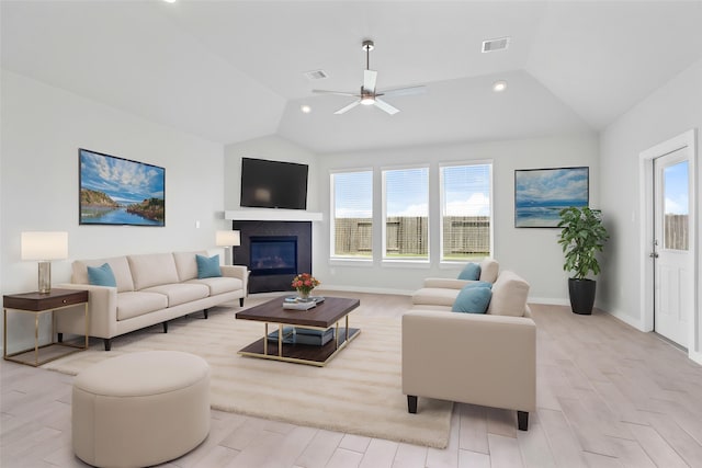 352 Spruce Oak Ln, Waller, TX 77484 - living area featuring vaulted ceiling, light wood-type flooring, a ceiling fan, a glass covered fireplace, and recessed lighting