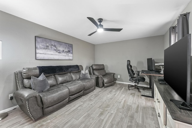 office space with light wood-style flooring, baseboards, and ceiling fan