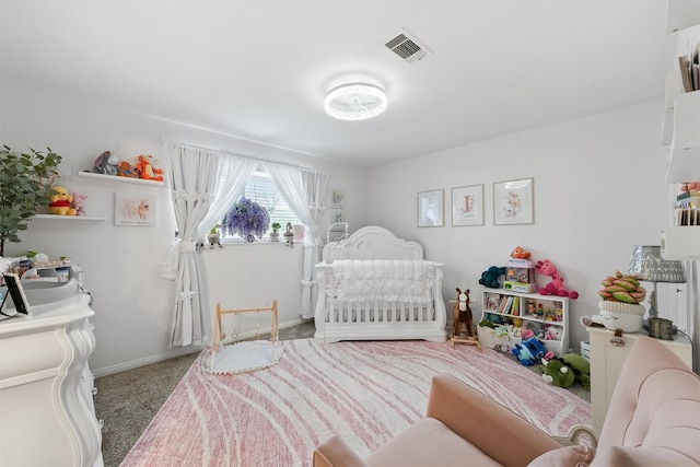 bedroom with visible vents, carpet floors, baseboards, and a crib