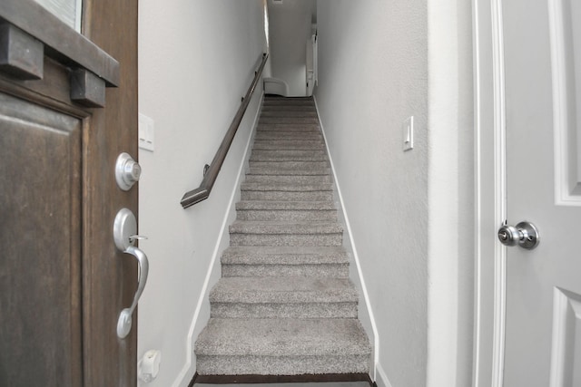 staircase featuring baseboards