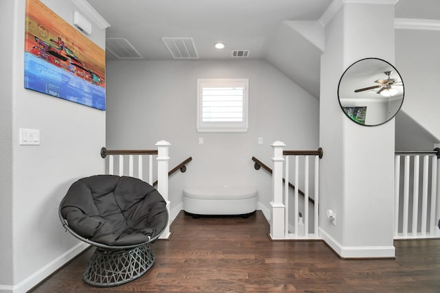 interior space featuring ceiling fan, wood finished floors, visible vents, and baseboards