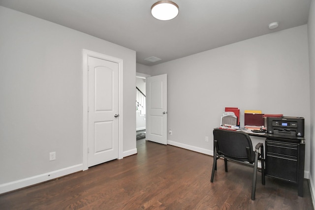 office space featuring visible vents, baseboards, and wood finished floors