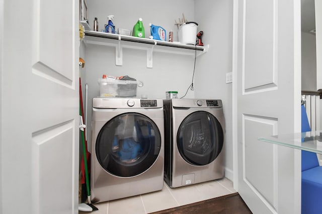 laundry room featuring tile patterned flooring, laundry area, and washing machine and dryer