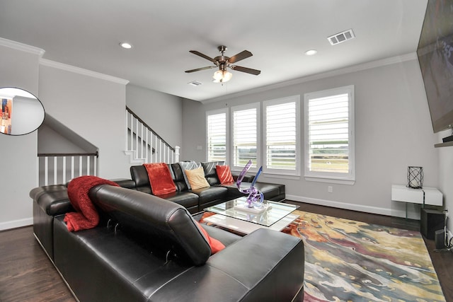 living area featuring visible vents, ornamental molding, a ceiling fan, dark wood-style floors, and baseboards