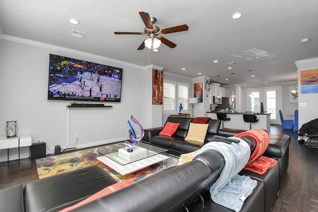 living area featuring ornamental molding, a healthy amount of sunlight, visible vents, and ceiling fan