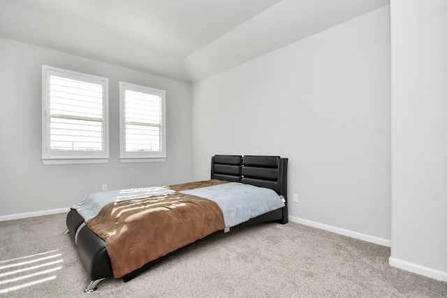 bedroom featuring carpet flooring, baseboards, and vaulted ceiling