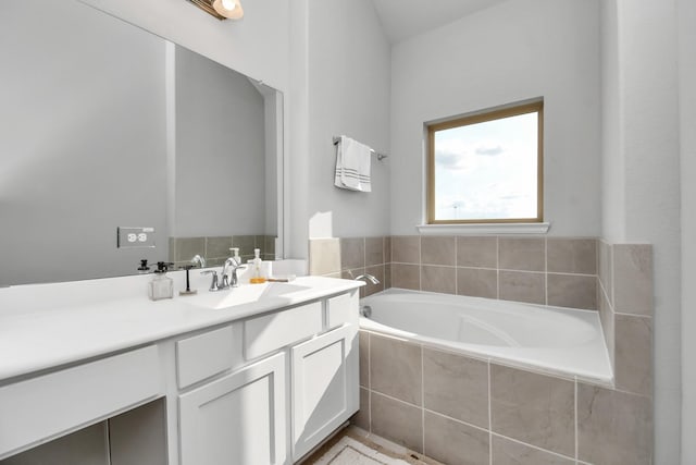 full bathroom with vanity and a bath