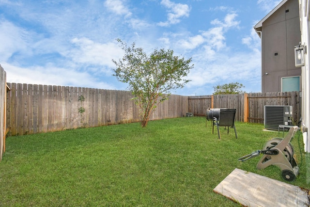 view of yard featuring central air condition unit and a fenced backyard