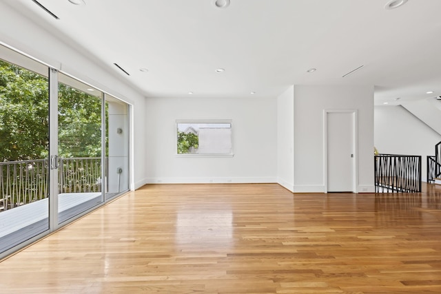 empty room with recessed lighting, baseboards, and light wood finished floors