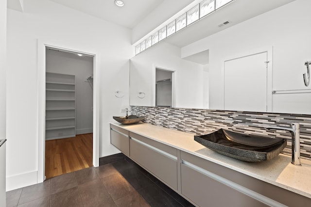 bathroom featuring tile patterned flooring, tasteful backsplash, vanity, and visible vents