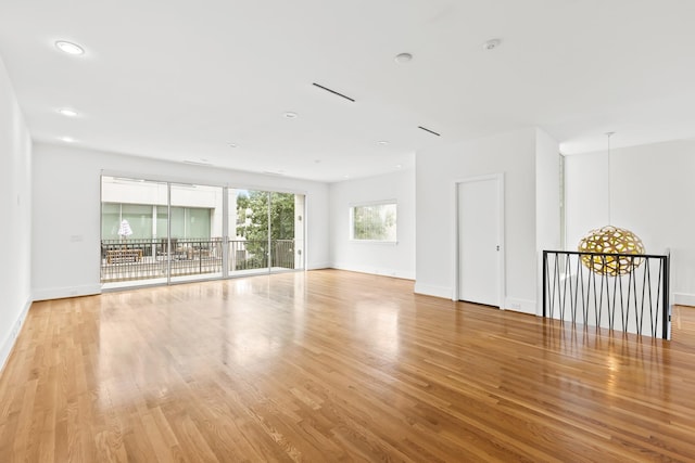 unfurnished room with recessed lighting, baseboards, and light wood-style floors