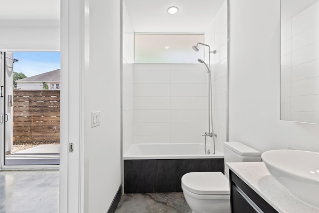 bathroom with toilet, vanity, and bathing tub / shower combination