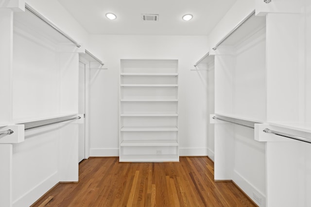 walk in closet with visible vents and wood finished floors