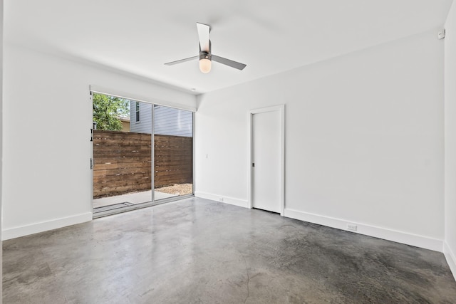 unfurnished bedroom featuring finished concrete flooring, baseboards, and a ceiling fan