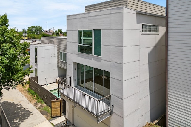 view of side of property with a balcony