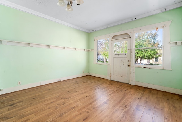 entrance foyer featuring ornamental molding, baseboards, and hardwood / wood-style floors