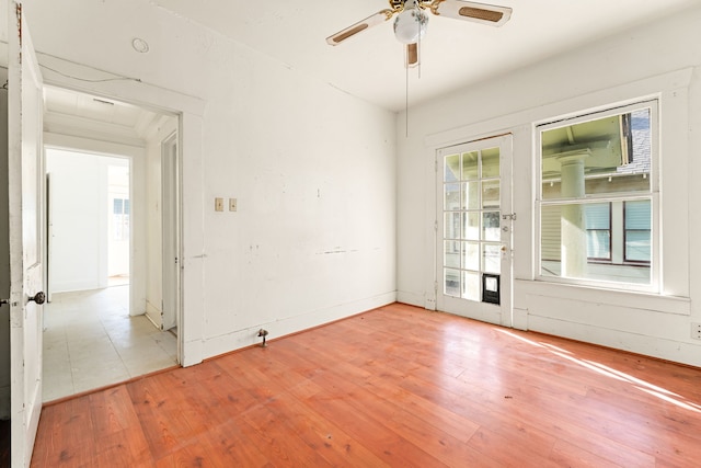 spare room with a ceiling fan and light wood-style floors
