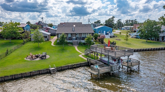 dock area with a yard, a deck with water view, and an outdoor fire pit