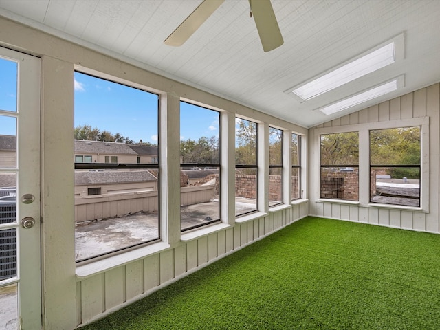 unfurnished sunroom featuring vaulted ceiling and a ceiling fan