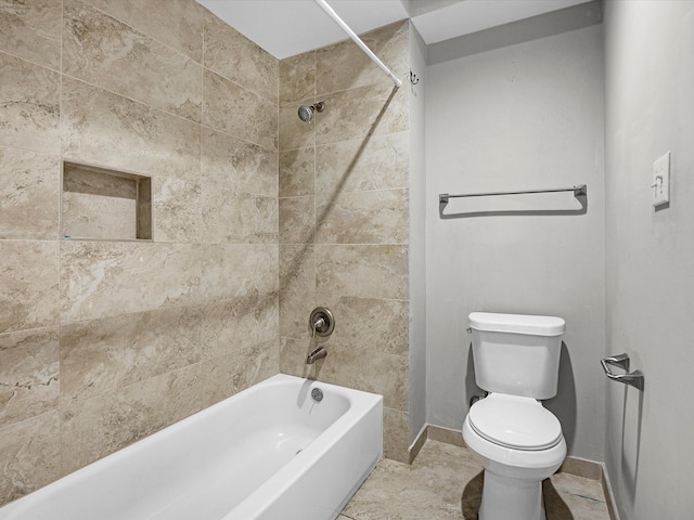 bathroom featuring shower / bath combination, baseboards, and toilet