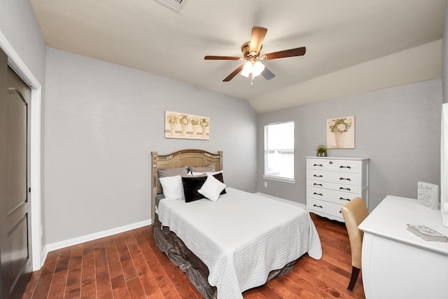 bedroom with dark wood finished floors, lofted ceiling, a ceiling fan, and baseboards