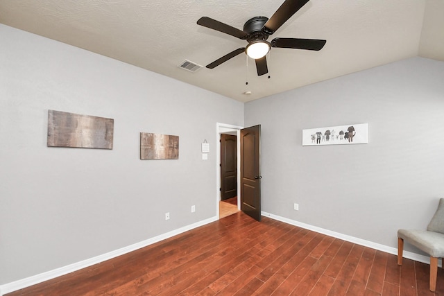 unfurnished bedroom featuring wood finished floors, visible vents, baseboards, lofted ceiling, and ceiling fan