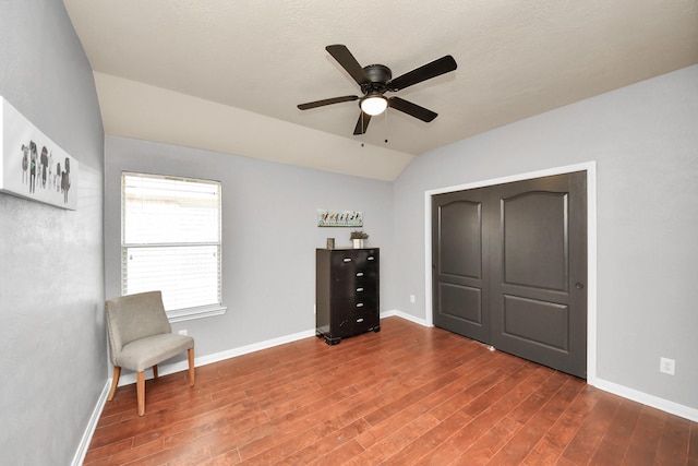 unfurnished room with ceiling fan, baseboards, lofted ceiling, and wood finished floors