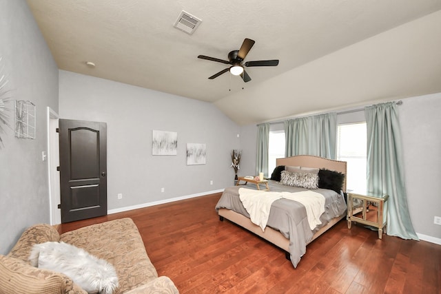 bedroom with visible vents, wood finished floors, baseboards, lofted ceiling, and ceiling fan