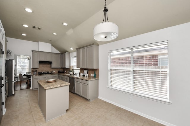 kitchen with visible vents, gray cabinetry, stainless steel appliances, and a sink