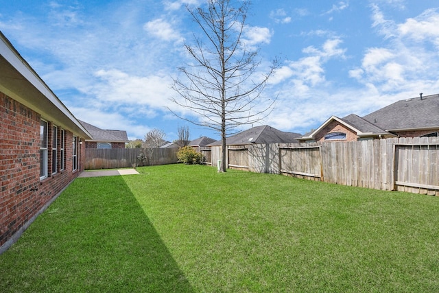 view of yard with a fenced backyard