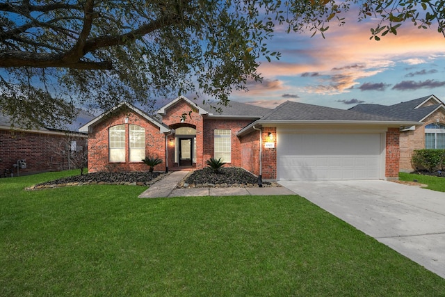 ranch-style home with concrete driveway, a front yard, a shingled roof, a garage, and brick siding