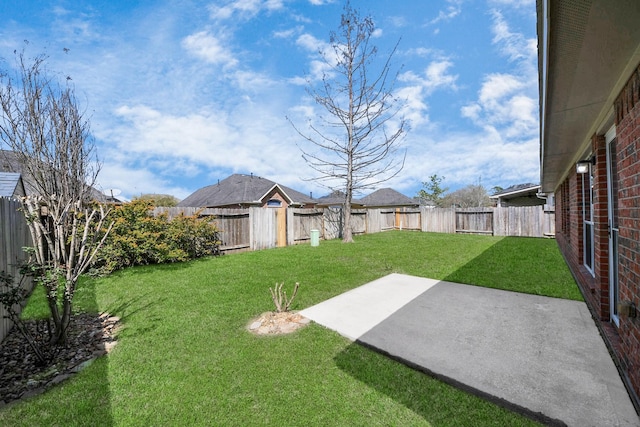 view of yard featuring a patio area and a fenced backyard