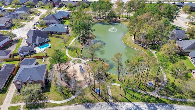 drone / aerial view with a residential view and a water view