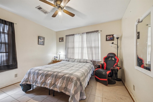 tiled bedroom featuring visible vents, baseboards, and ceiling fan