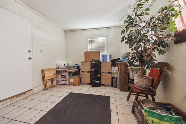 interior space with tile patterned floors and crown molding