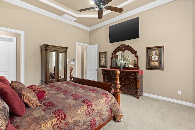 bedroom featuring baseboards, carpet floors, a tray ceiling, ceiling fan, and crown molding