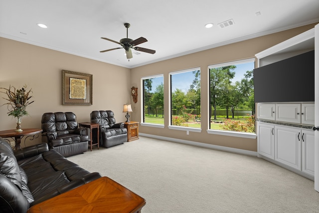 living room with visible vents, light carpet, a ceiling fan, and crown molding