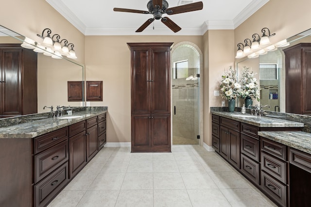 bathroom featuring tile patterned floors, ornamental molding, a ceiling fan, and a sink