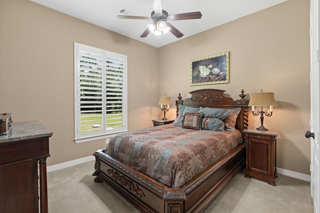 bedroom featuring light colored carpet, a ceiling fan, and baseboards