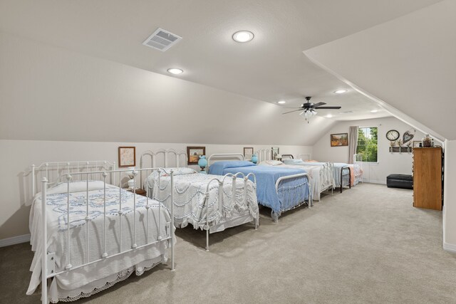 bedroom featuring visible vents, baseboards, carpet, vaulted ceiling, and a ceiling fan