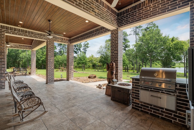 view of patio / terrace with ceiling fan, an outdoor fire pit, area for grilling, and grilling area