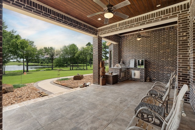 view of patio featuring grilling area, area for grilling, ceiling fan, and a water view