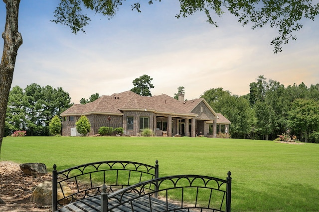 exterior space with a front yard and brick siding