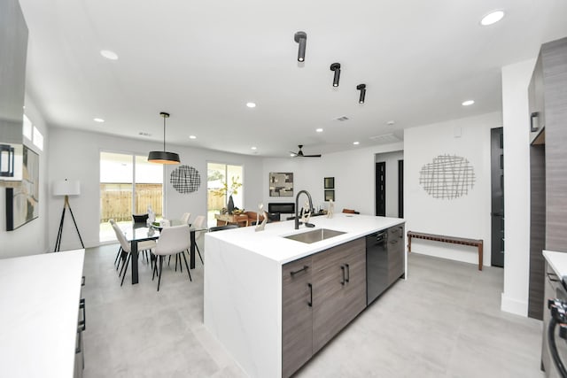 kitchen with recessed lighting, a sink, light countertops, black dishwasher, and modern cabinets