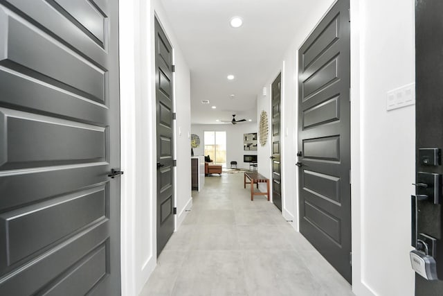 hall featuring recessed lighting and light tile patterned flooring