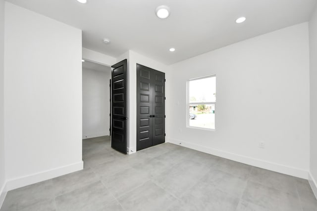 unfurnished bedroom with recessed lighting and baseboards