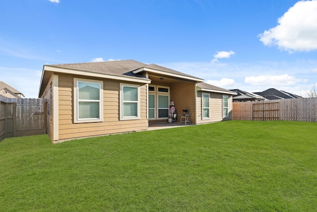 back of house with a patio, a yard, and a fenced backyard