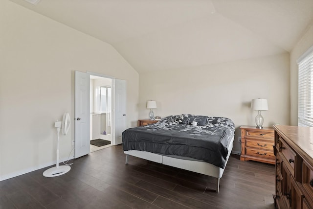 bedroom featuring baseboards, lofted ceiling, and dark wood-type flooring