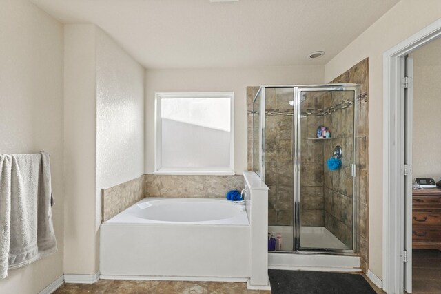 full bath with a garden tub and a shower stall