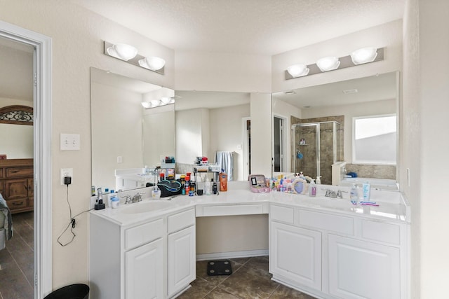 full bath featuring double vanity, a shower stall, and a sink